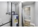 A water heater and a view into a bathroom in a basement setting at 1980 Taylor Lake Cir, Largo, FL 33778