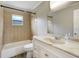 Updated bathroom with a vanity and tiled shower/tub combo at 1980 Taylor Lake Cir, Largo, FL 33778