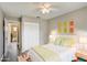 Virtually staged bedroom with wood flooring, colorful decor, and an ensuite at 1980 Taylor Lake Cir, Largo, FL 33778