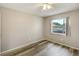 This bedroom features wood floors, neutral walls, and a ceiling fan at 1980 Taylor Lake Cir, Largo, FL 33778