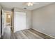 Bedroom featuring light gray walls, wood-look flooring, and a closet with white bi-fold doors at 1980 Taylor Lake Cir, Largo, FL 33778