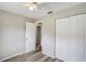 Bedroom featuring wood flooring, a closet, and neutral paint at 1980 Taylor Lake Cir, Largo, FL 33778