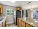 Kitchen featuring light wood cabinets, stone countertops, stainless steel appliances, and natural light at 1980 Taylor Lake Cir, Largo, FL 33778