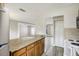Open kitchen area with light wood cabinets, stainless steel appliances and a breakfast bar at 1980 Taylor Lake Cir, Largo, FL 33778