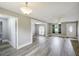 This open-concept living room features wood floors and a view into the adjacent dining and kitchen areas at 1980 Taylor Lake Cir, Largo, FL 33778