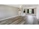 Open-concept living room area featuring new flooring and seamless flow to the kitchen and dining areas at 1980 Taylor Lake Cir, Largo, FL 33778
