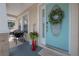 Charming front entrance featuring a decorative wreath, blue door, and cozy seating area at 204 W Fern St, Tampa, FL 33604
