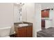 Half bathroom with vanity, granite countertops, and a view into an adjoining room at 2130 W Spruce St, Tampa, FL 33607