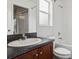 Well-lit bathroom features dark counters, a sink and a bathtub at 2130 W Spruce St, Tampa, FL 33607