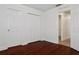 Cozy bedroom with hardwood floors, closet, and neutral walls at 2130 W Spruce St, Tampa, FL 33607