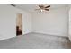 A bright, carpeted bedroom with white walls, a window, and an ensuite bathroom at 2130 W Spruce St, Tampa, FL 33607