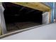 View of the crawlspace, with moisture barrier, accessible from the outside of the property at 2130 W Spruce St, Tampa, FL 33607