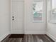 Well-lit entrance with white door and window letting in natural light, creating inviting space at 2130 W Spruce St, Tampa, FL 33607