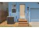 Charming home exterior features a welcoming back entrance, air conditioner and one car garage at 2130 W Spruce St, Tampa, FL 33607