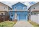 Charming blue two-story home with garage and well-maintained front yard, perfect for curb appeal at 2130 W Spruce St, Tampa, FL 33607