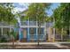 Charming two-story home with a welcoming front porch, blue exterior, and a manicured front yard at 2130 W Spruce St, Tampa, FL 33607