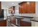 A modern kitchen features stainless steel appliances, dark granite counters, and cherry cabinets at 2130 W Spruce St, Tampa, FL 33607