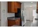 Modern kitchen with stainless steel appliances, dark granite counters, and wood cabinets at 2130 W Spruce St, Tampa, FL 33607
