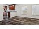 View of the kitchen showing wood cabinetry and a breakfast bar that open to the living area at 2130 W Spruce St, Tampa, FL 33607