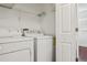 Convenient laundry area with modern washer and dryer, and ample shelving at 2130 W Spruce St, Tampa, FL 33607