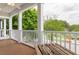 Inviting front porch with white columns, a ceiling fan, and outdoor seating at 2130 W Spruce St, Tampa, FL 33607