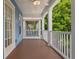 Inviting porch with ceiling fan and wooden floors, perfect for relaxing outdoors at 2130 W Spruce St, Tampa, FL 33607