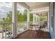 Front porch featuring white columns, wooden flooring, and outdoor seating at 2130 W Spruce St, Tampa, FL 33607