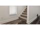 Carpeted staircase features a window that provides natural light, enhancing its appeal at 2130 W Spruce St, Tampa, FL 33607