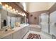 Elegant bathroom with dual vanities, ample counter space, and separate tub and shower at 2175 Oak Forest Ln, Palm Harbor, FL 34683