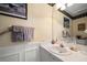 Cozy bathroom featuring a sink, framed mirror, and decorative wallpaper border at 2175 Oak Forest Ln, Palm Harbor, FL 34683