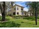 Side view of a lovely two-story home featuring a screened-in porch at 2175 Oak Forest Ln, Palm Harbor, FL 34683