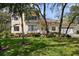 Charming two-story home with a well-manicured lawn and lovely landscaping in front at 2175 Oak Forest Ln, Palm Harbor, FL 34683