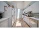 Bright kitchen featuring white cabinetry, modern appliances and blue and white checkered wallpaper at 2175 Oak Forest Ln, Palm Harbor, FL 34683