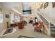 Spacious living room with high ceilings, a fireplace, and staircase to the second level at 2175 Oak Forest Ln, Palm Harbor, FL 34683