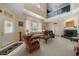 Bright living room with a fireplace, a high ceiling, and many windows at 2175 Oak Forest Ln, Palm Harbor, FL 34683