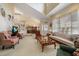 Bright, open living room with stairs leading to a loft and access to the dining room at 2175 Oak Forest Ln, Palm Harbor, FL 34683