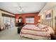Bright bedroom with colorful accent wall, classic furniture, and plenty of natural light at 2175 Oak Forest Ln, Palm Harbor, FL 34683