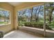 Relaxing screened-in patio with tile flooring and a serene view of the landscaped community at 2175 Oak Forest Ln, Palm Harbor, FL 34683