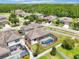 Overhead view showing the house with a screened-in pool and generous backyard in a residential community at 21834 Southern Charm Dr, Land O Lakes, FL 34637