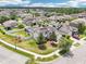 Expansive aerial view showcasing a two-story home with a large backyard, landscaping, and a suburban setting at 21834 Southern Charm Dr, Land O Lakes, FL 34637