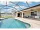 Inviting screened-in pool area with comfortable patio furniture and outdoor grill at 21834 Southern Charm Dr, Land O Lakes, FL 34637
