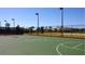 Community basketball court with green surface, black fencing, and neighborhood backdrop at 21834 Southern Charm Dr, Land O Lakes, FL 34637