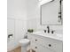 Stylish half bathroom featuring a modern vanity with a black faucet and a decorative mirror at 21834 Southern Charm Dr, Land O Lakes, FL 34637