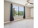 Bedroom featuring large window, dark curtains, and neutral paint at 21834 Southern Charm Dr, Land O Lakes, FL 34637