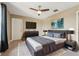 Bedroom with a ceiling fan, dresser, TV, and gray color accents at 21834 Southern Charm Dr, Land O Lakes, FL 34637