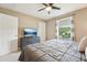 Comfortable bedroom with ceiling fan, tv, neutral colors and natural light at 21834 Southern Charm Dr, Land O Lakes, FL 34637