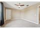 Bright bedroom with neutral walls, a ceiling fan and a closet door at 21834 Southern Charm Dr, Land O Lakes, FL 34637