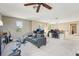 Spacious bonus room with neutral carpet, ceiling fan, and ample lighting at 21834 Southern Charm Dr, Land O Lakes, FL 34637