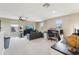 Bonus room area with neutral carpet, couch, TV, and multiple work spaces at 21834 Southern Charm Dr, Land O Lakes, FL 34637