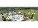 A sprawling community pool area with palm trees, a playground, and ample space for recreation and relaxation at 21834 Southern Charm Dr, Land O Lakes, FL 34637